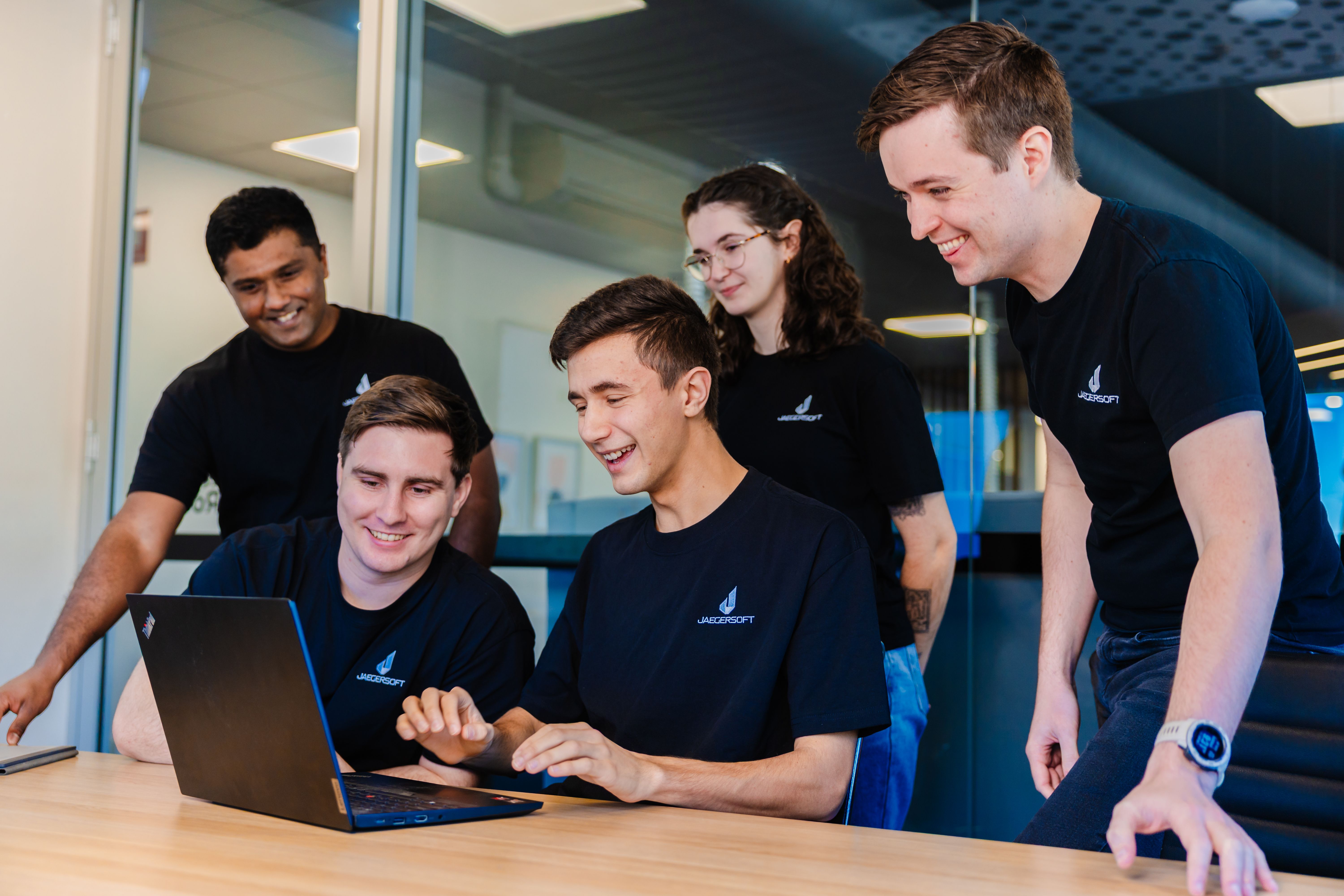 team looking at laptop